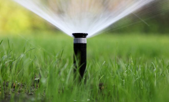 Sprinkler irrigating a commercial property in Grain Valley, MO